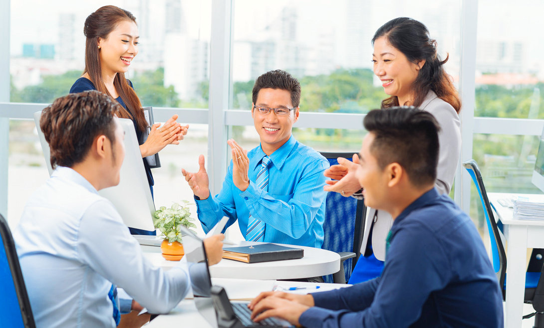 group of people clapping their hands